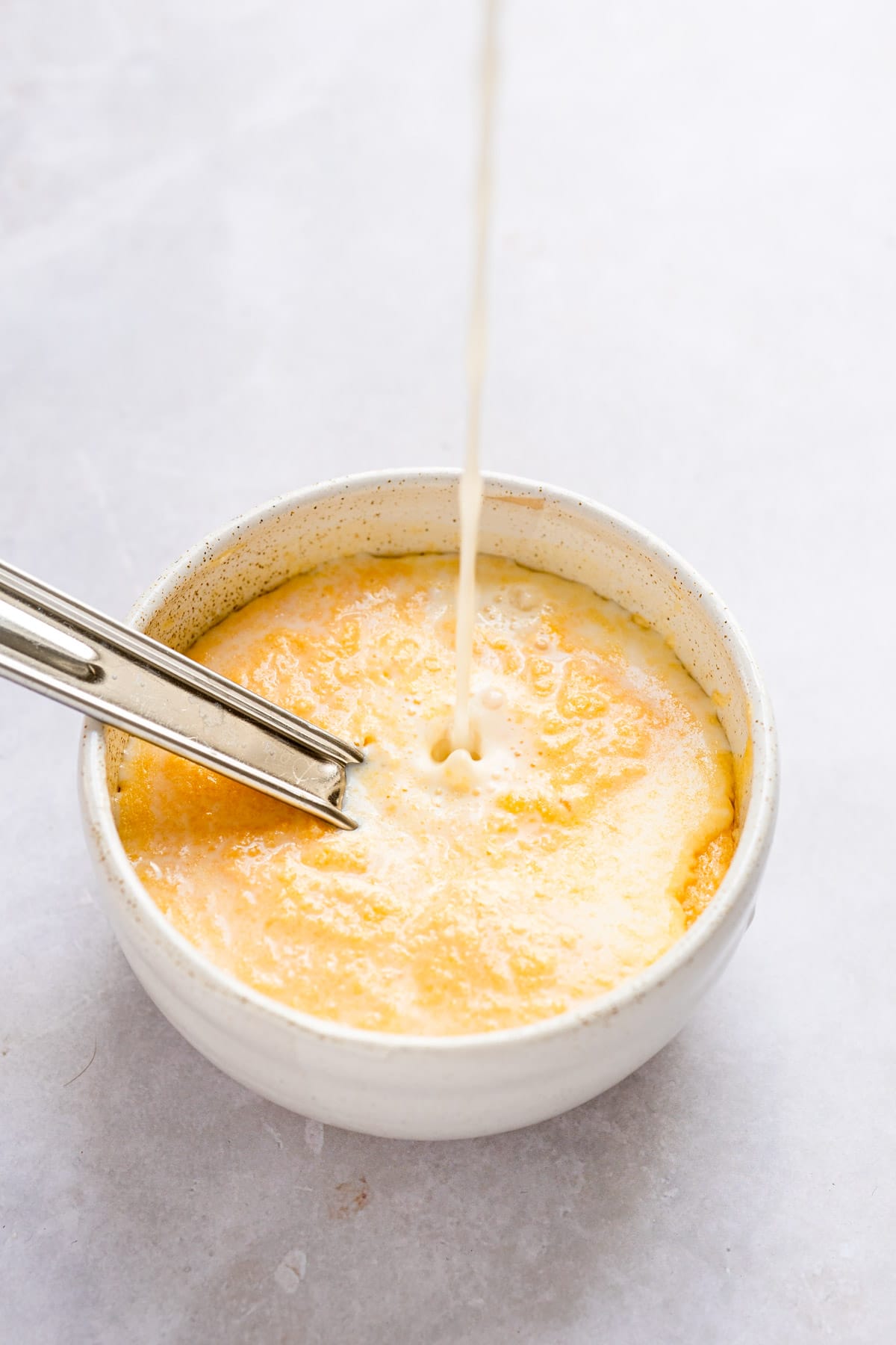 Milk streaming into lemon batter. 