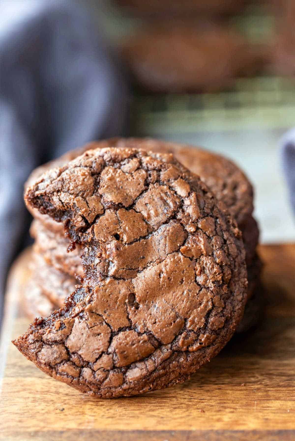 Brownie cookie standing up against a stack of brownie cookies.