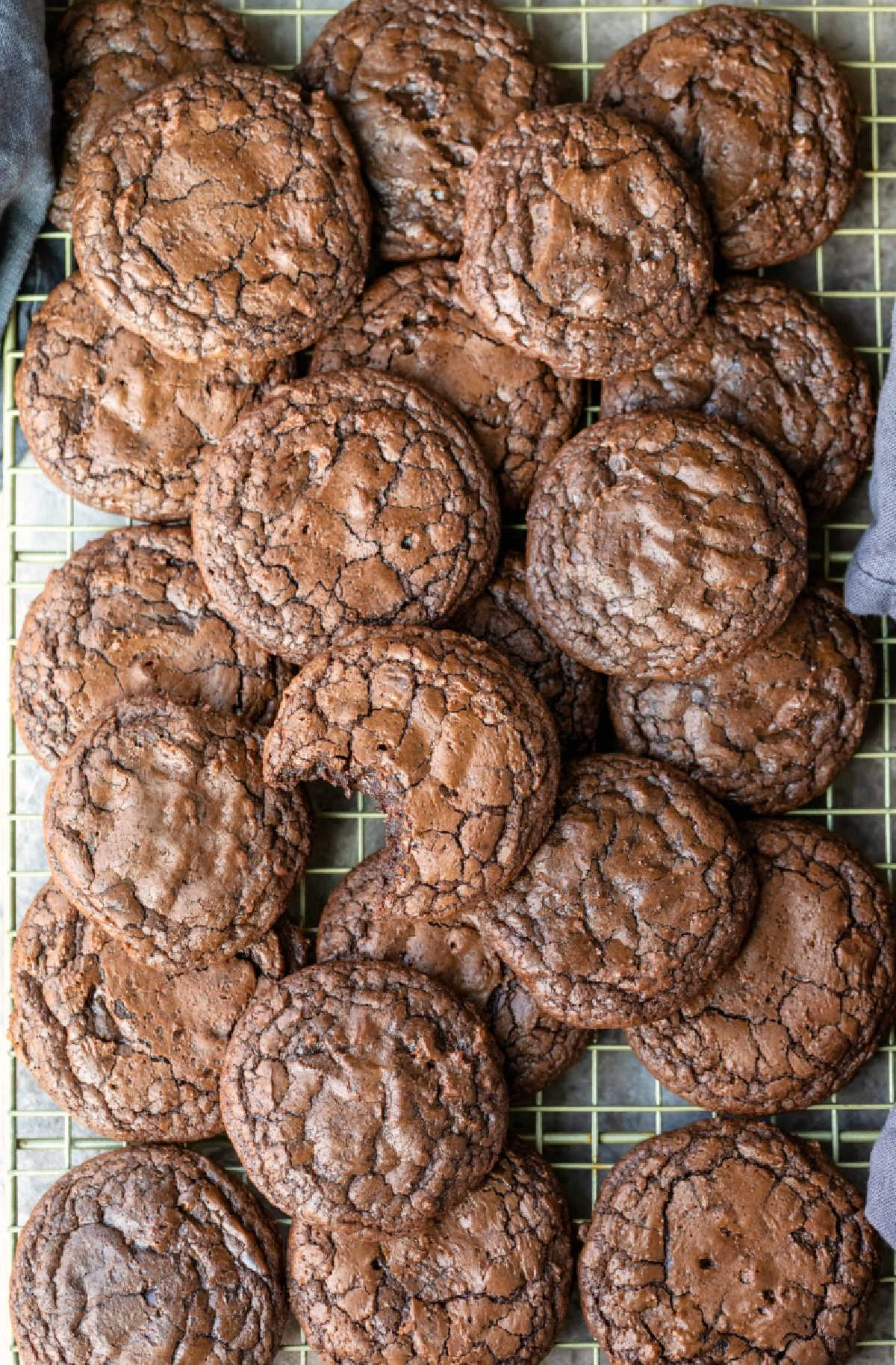 Stacks of brownie cookies on a wire cooling rack.