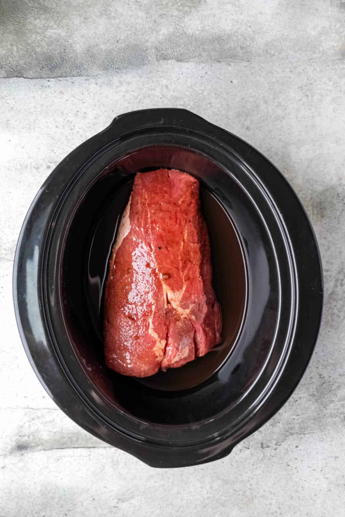 Roast covered in balsamic mixture in a slow cooker.
