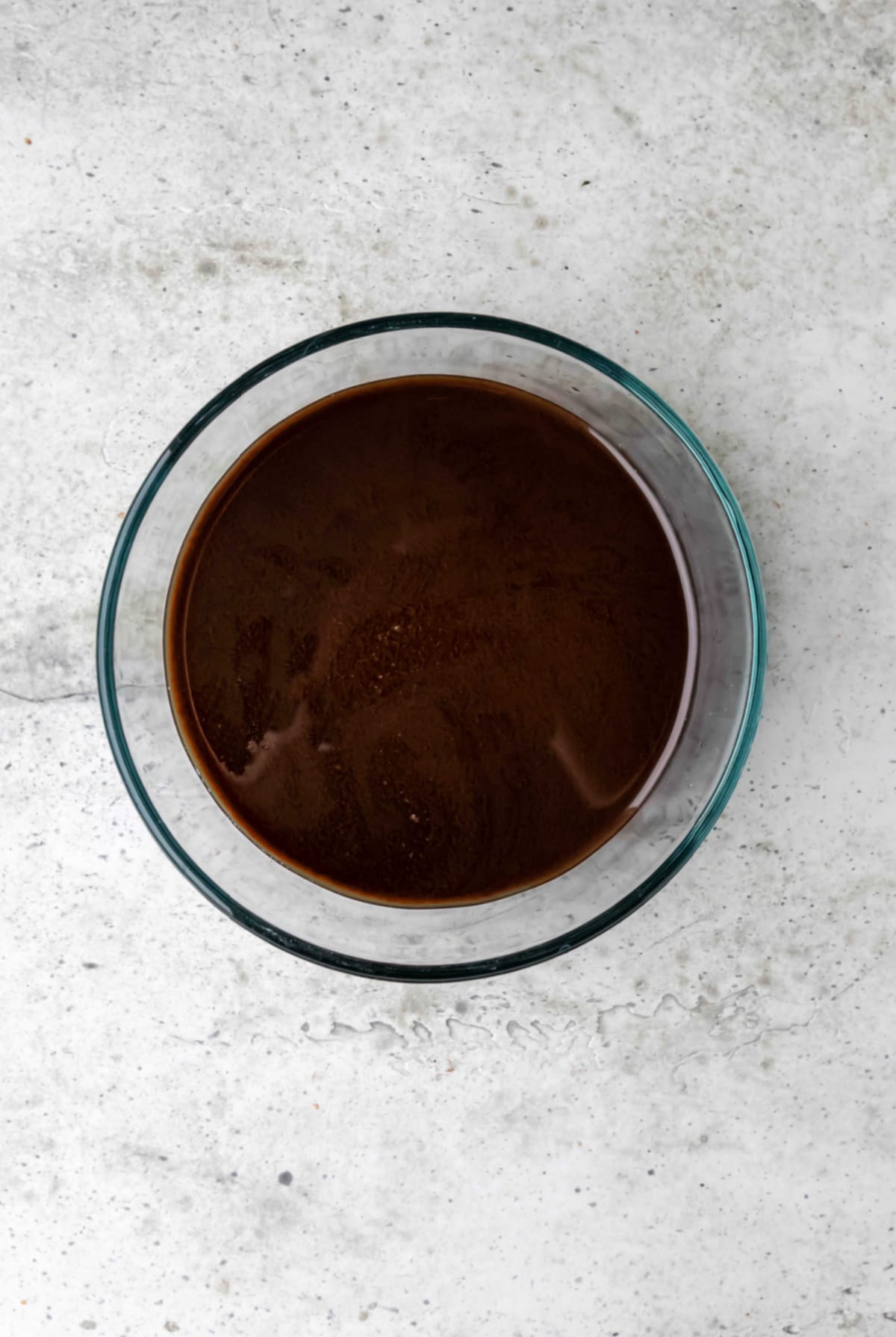 Balsamic vinegar sauce on a glass mixing bowl. 