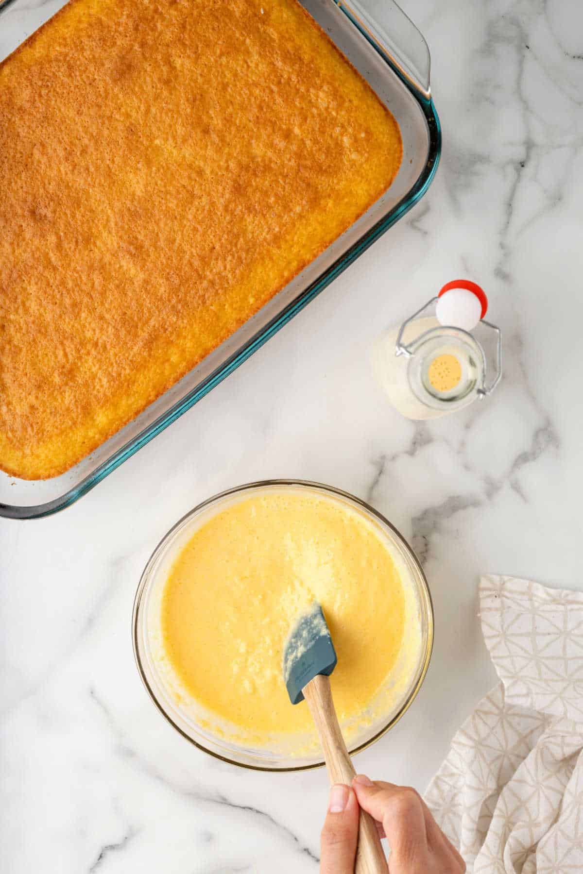 Eggnog and vanilla pudding mix in a glass mixing bowl. 