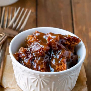 A cream ramekin with gingerbread pudding cake in it.