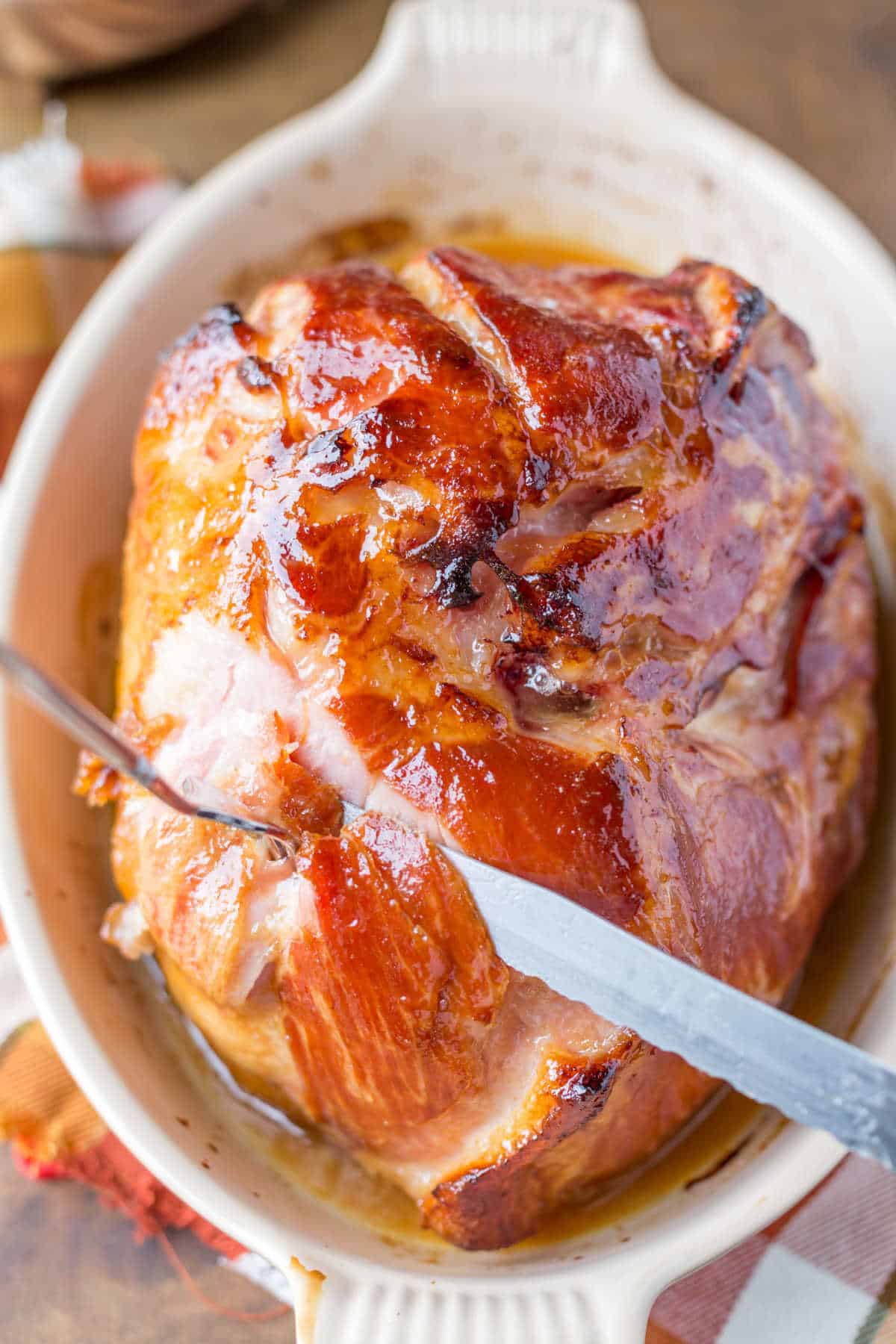 Knife cutting Maple Glazed Ham.