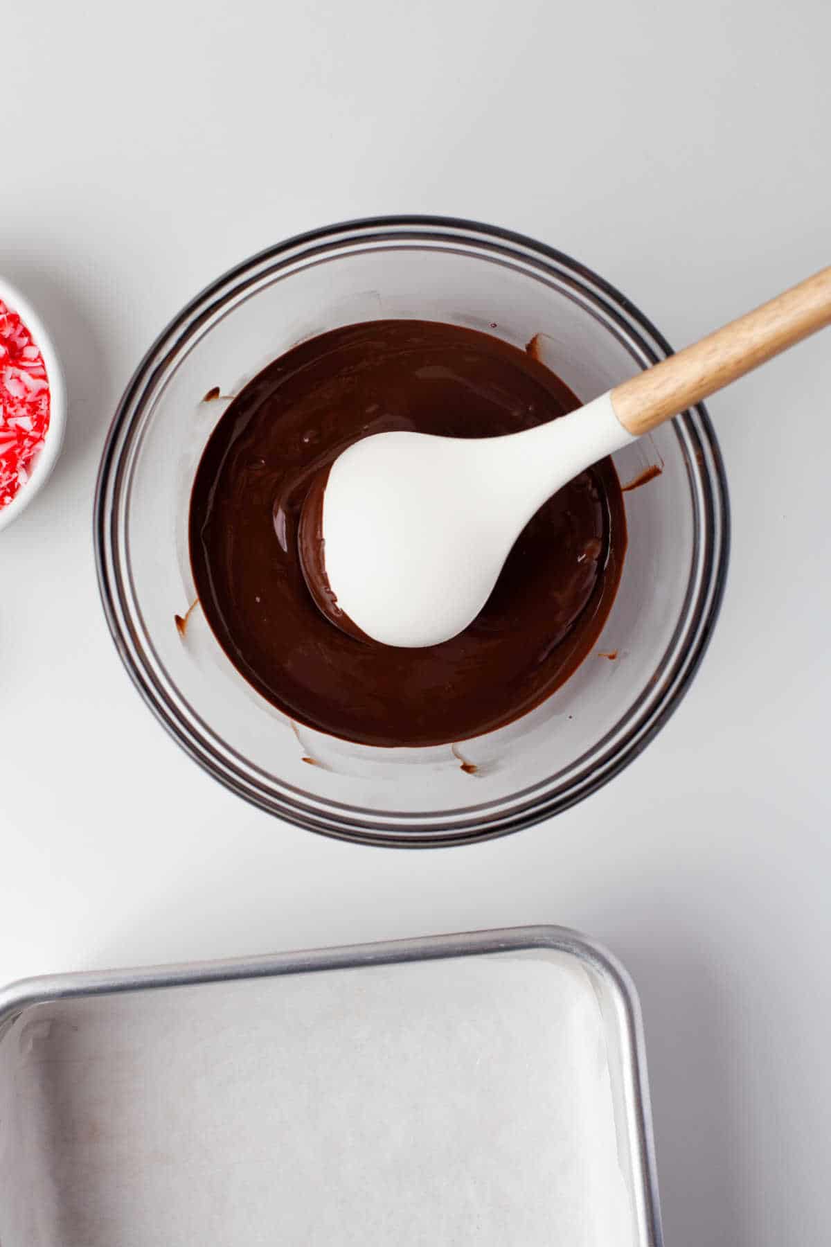 Melted chocolate in a glass mixing bowl.