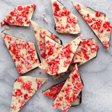 Peppermint bark in a stack on a marble background.