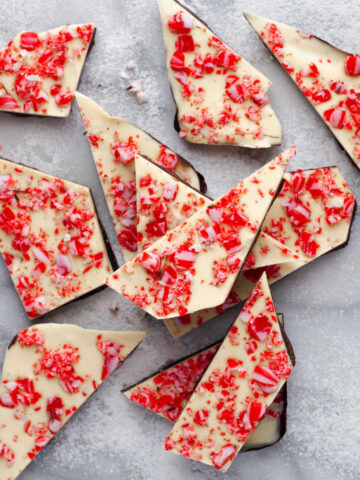 Peppermint bark in a stack on a marble background.