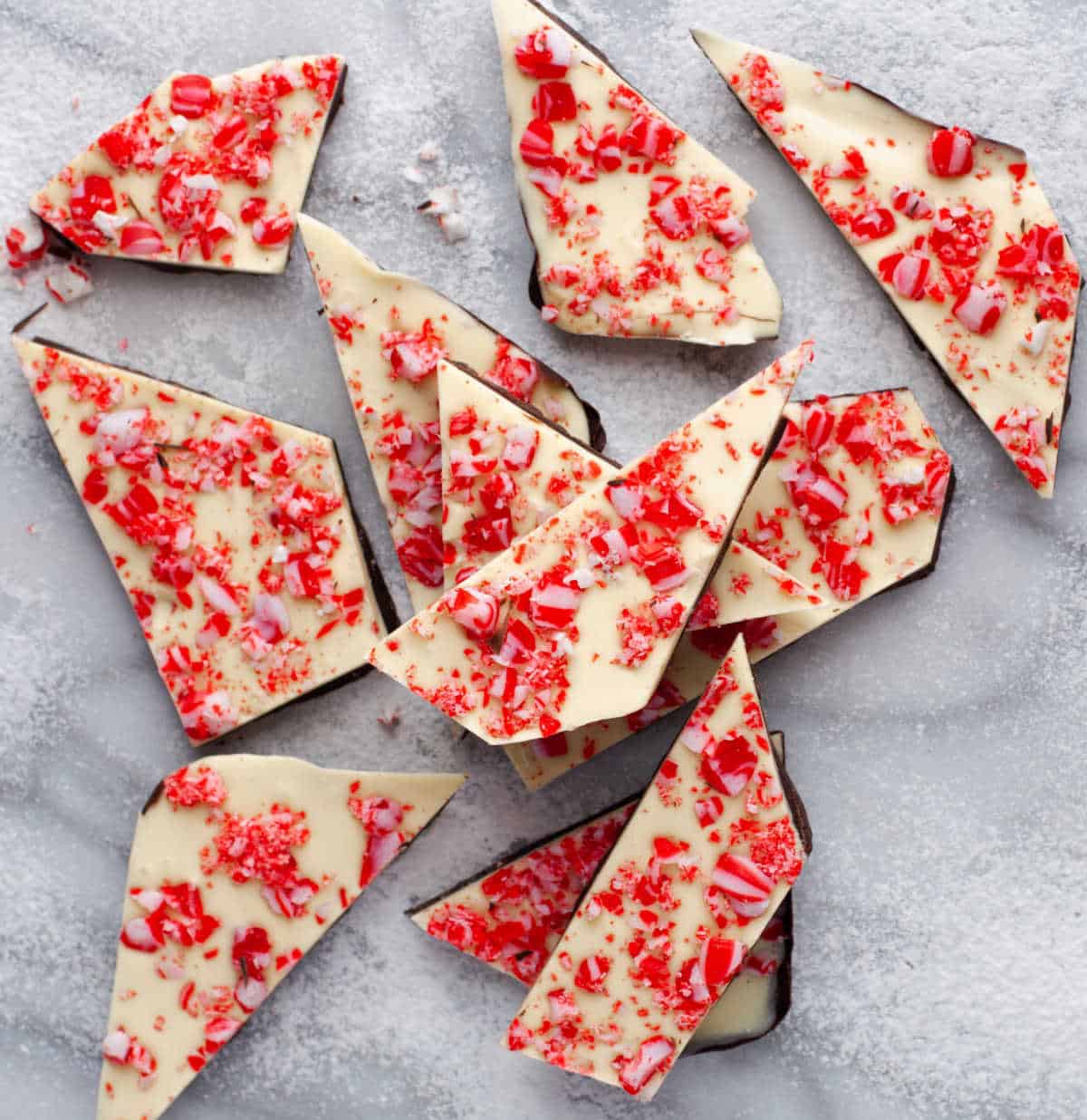 Peppermint bark in a stack on a marble background.