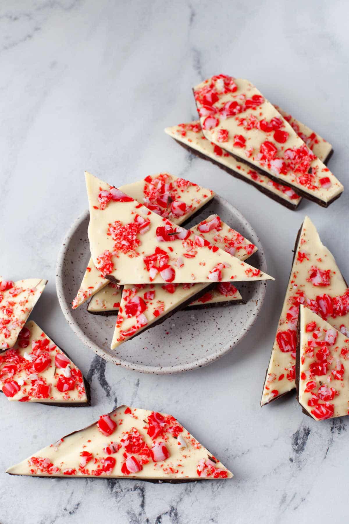 Stack of peppermint bark on a white plate. 