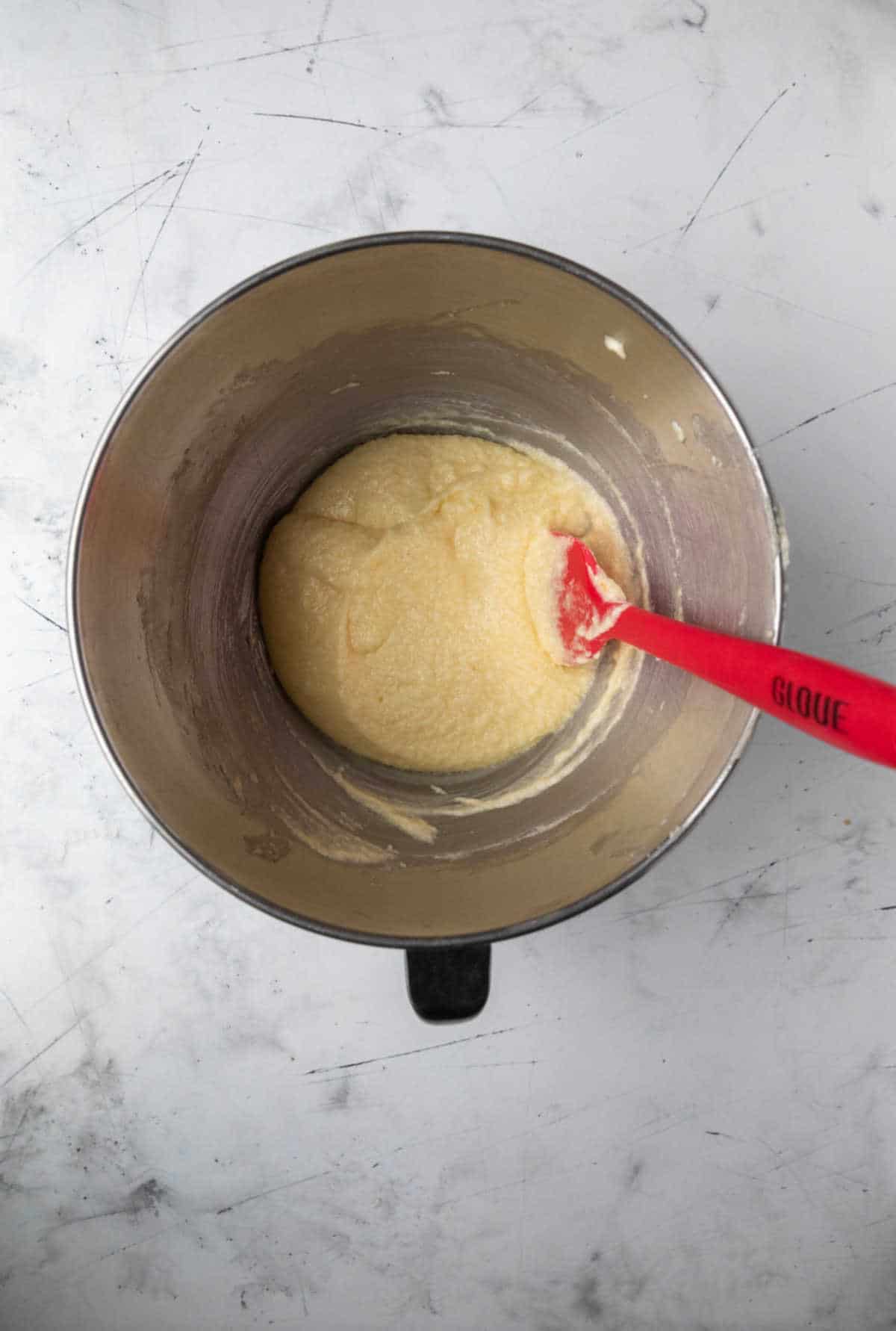 Eggs mixed into creamed butter and sugar.