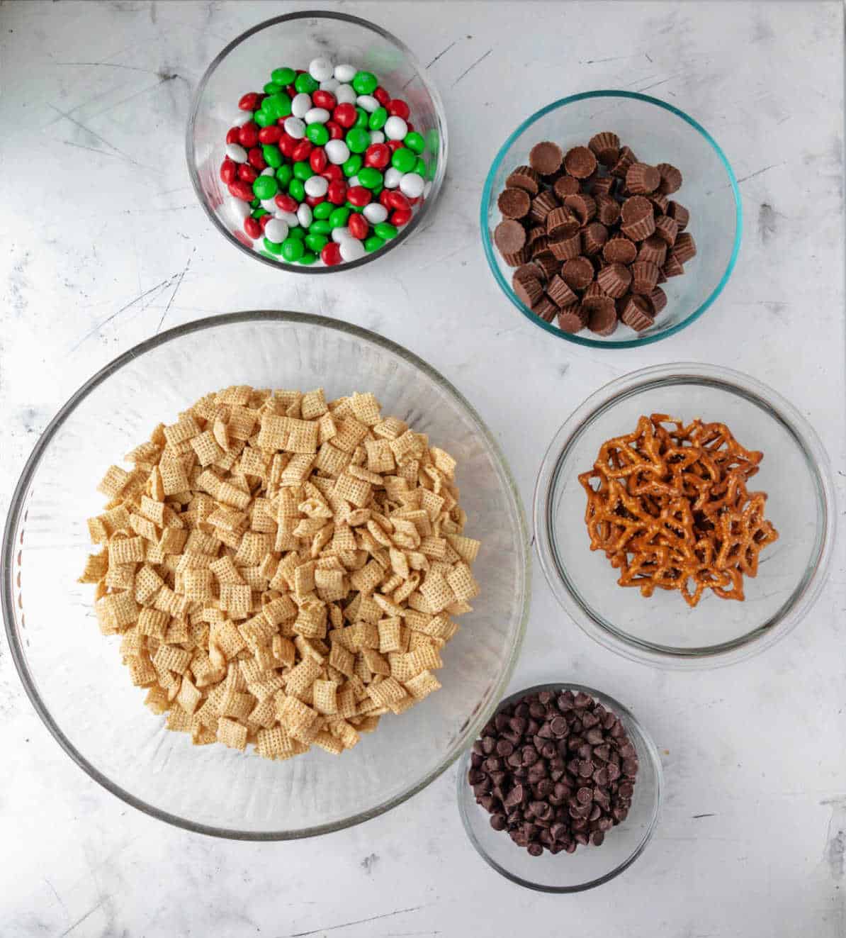 Ingredients for reindeer chow in glass bowls. 