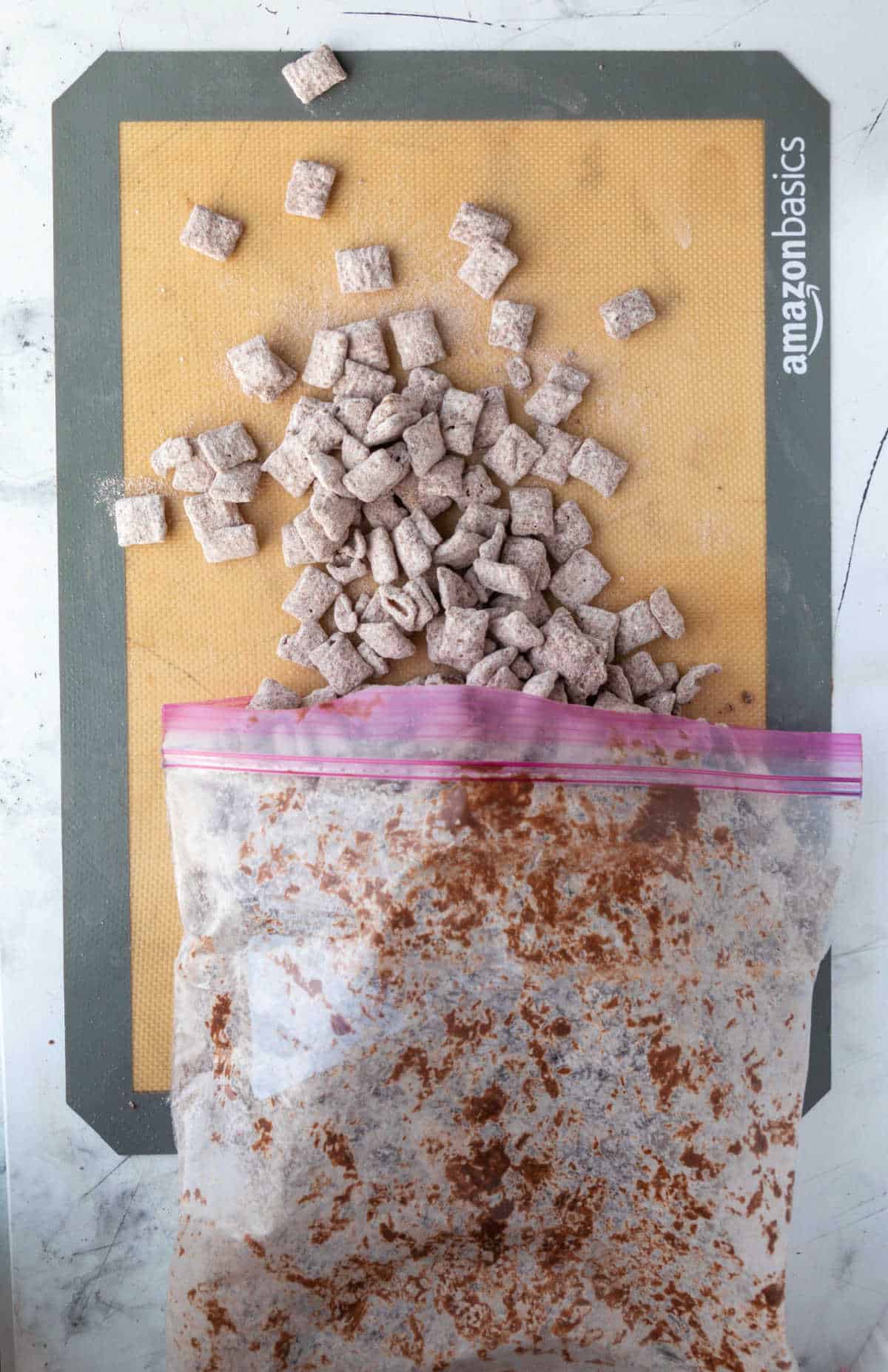 Muddy buddies spread on a silicone baking mat.