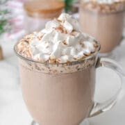 Mug of slow cooker hot chocolate topped with whipped cream.