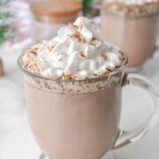 Mug of slow cooker hot chocolate topped with whipped cream.