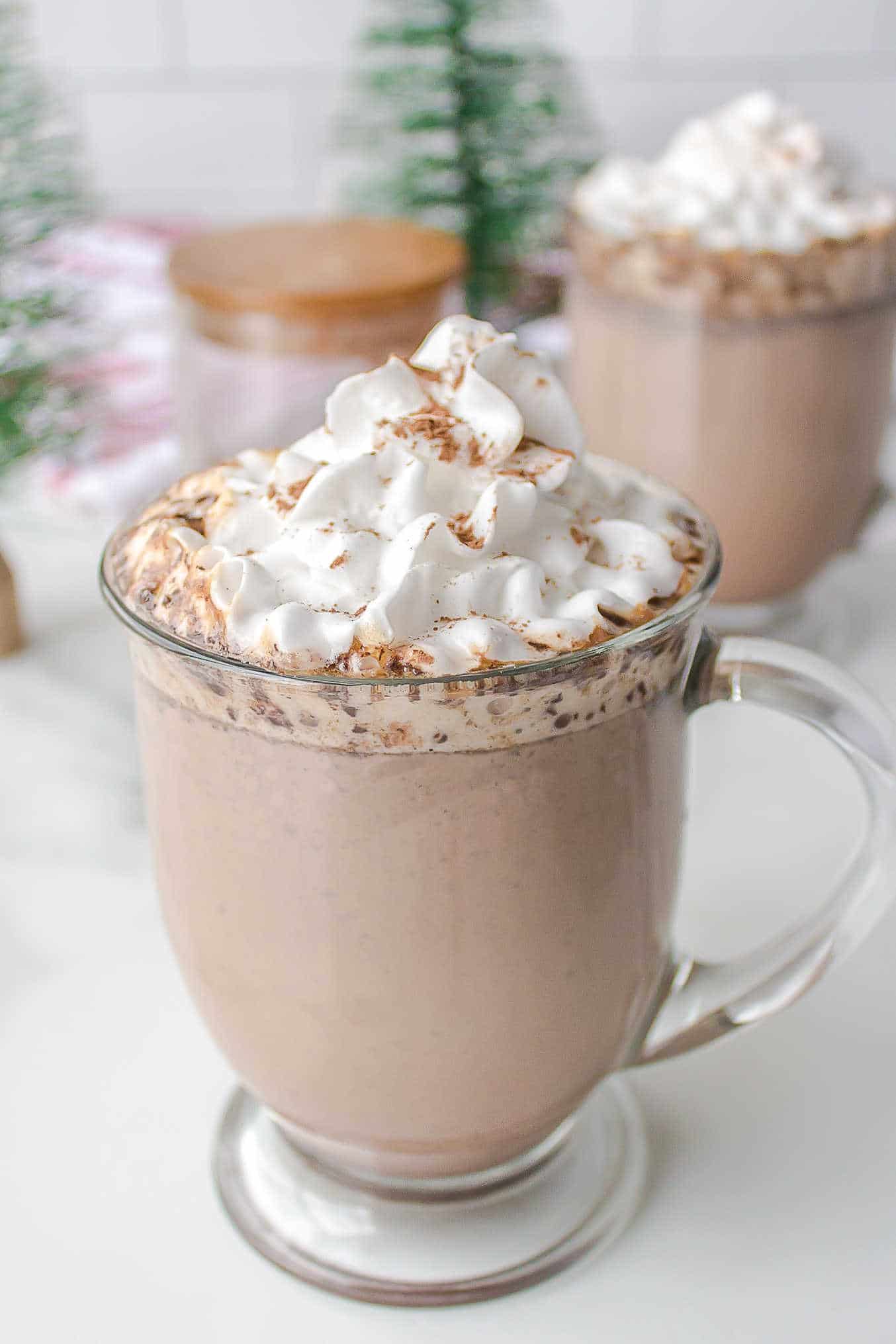 Mug of slow cooker hot chocolate topped with whipped cream.