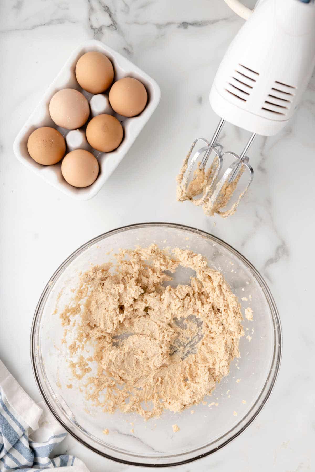 Creamed butter and sugar in a glass mixing bowl.