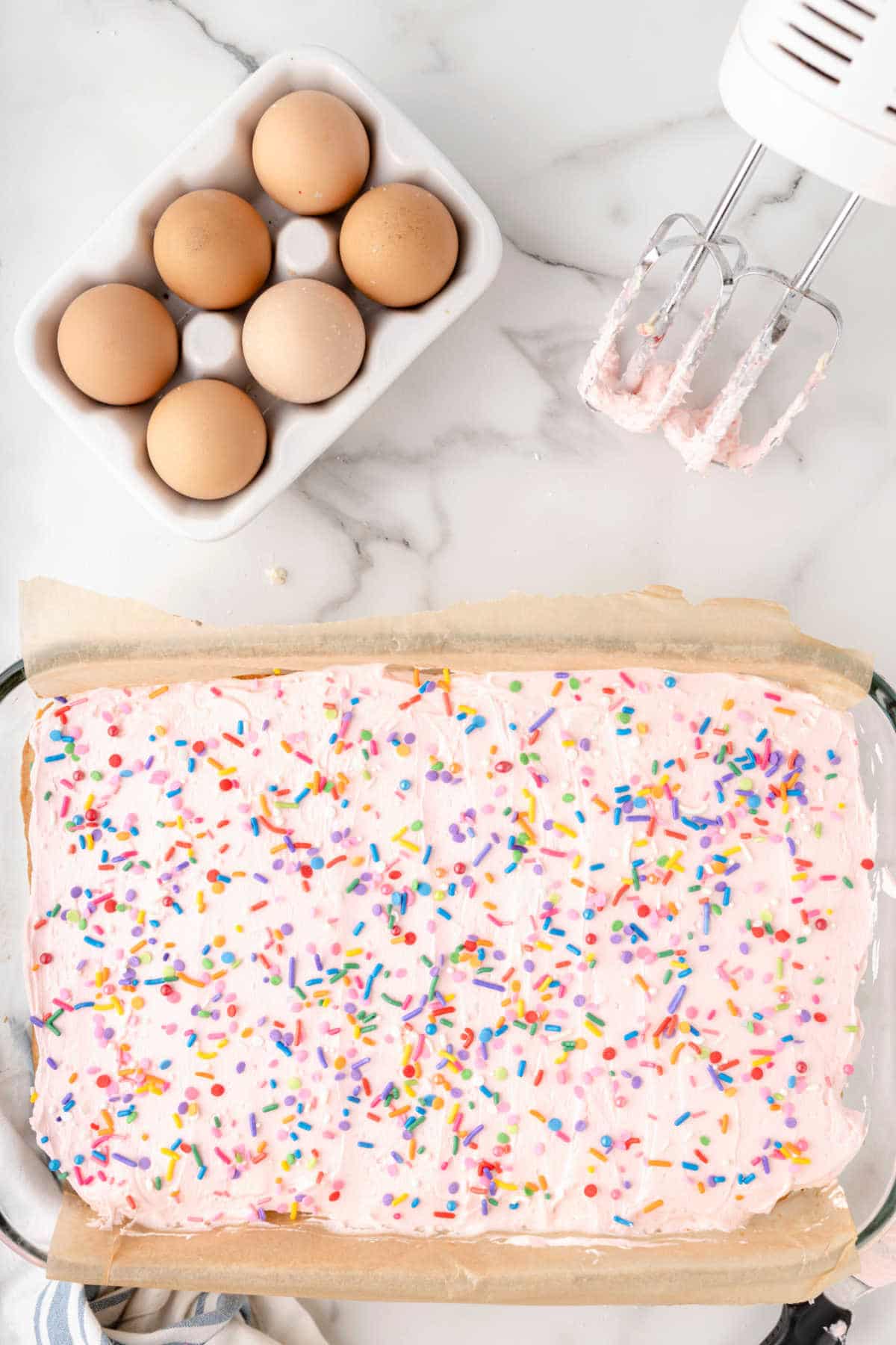 A pan of sugar cookie bars topped with sprinkles.