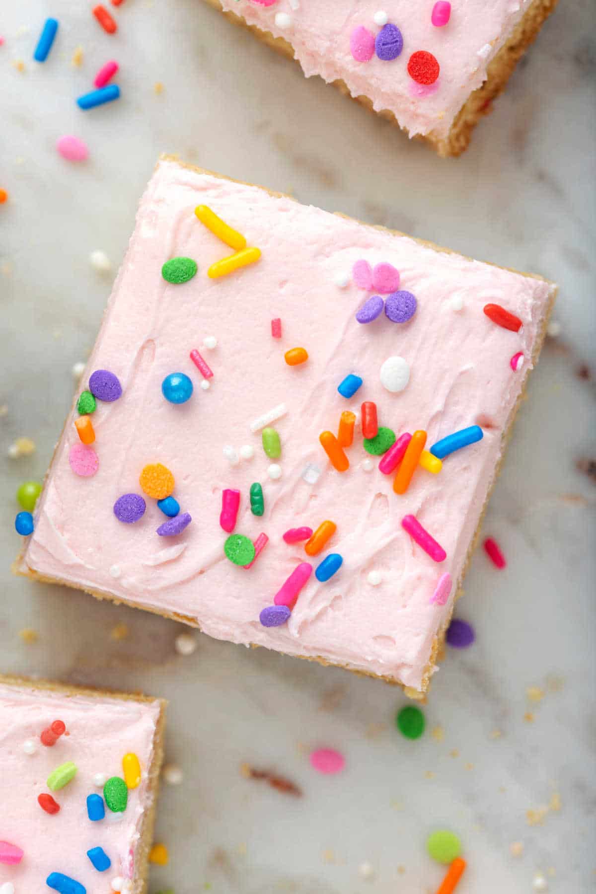 Close up photo of the top of a sugar cookie bar on a marble background.