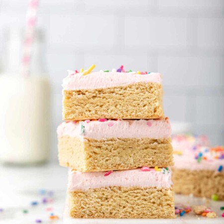 Stack of sugar cookie bars on a white platter.