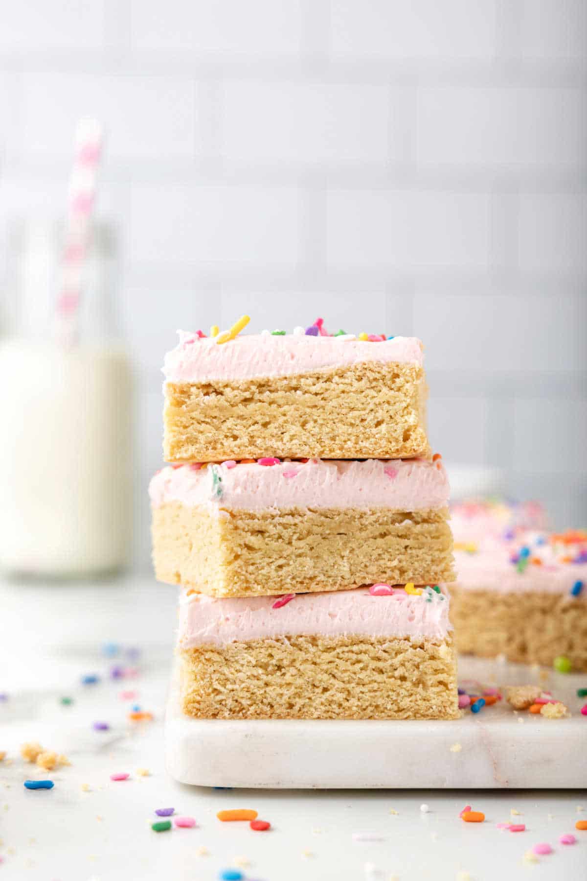 Stack of sugar cookie bars on a white platter.