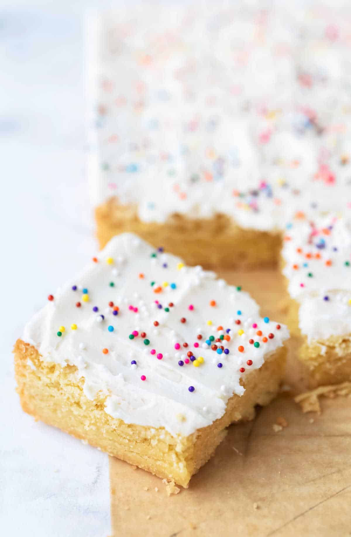 Sugar cookie bar pulled away from the pan at an angle. 