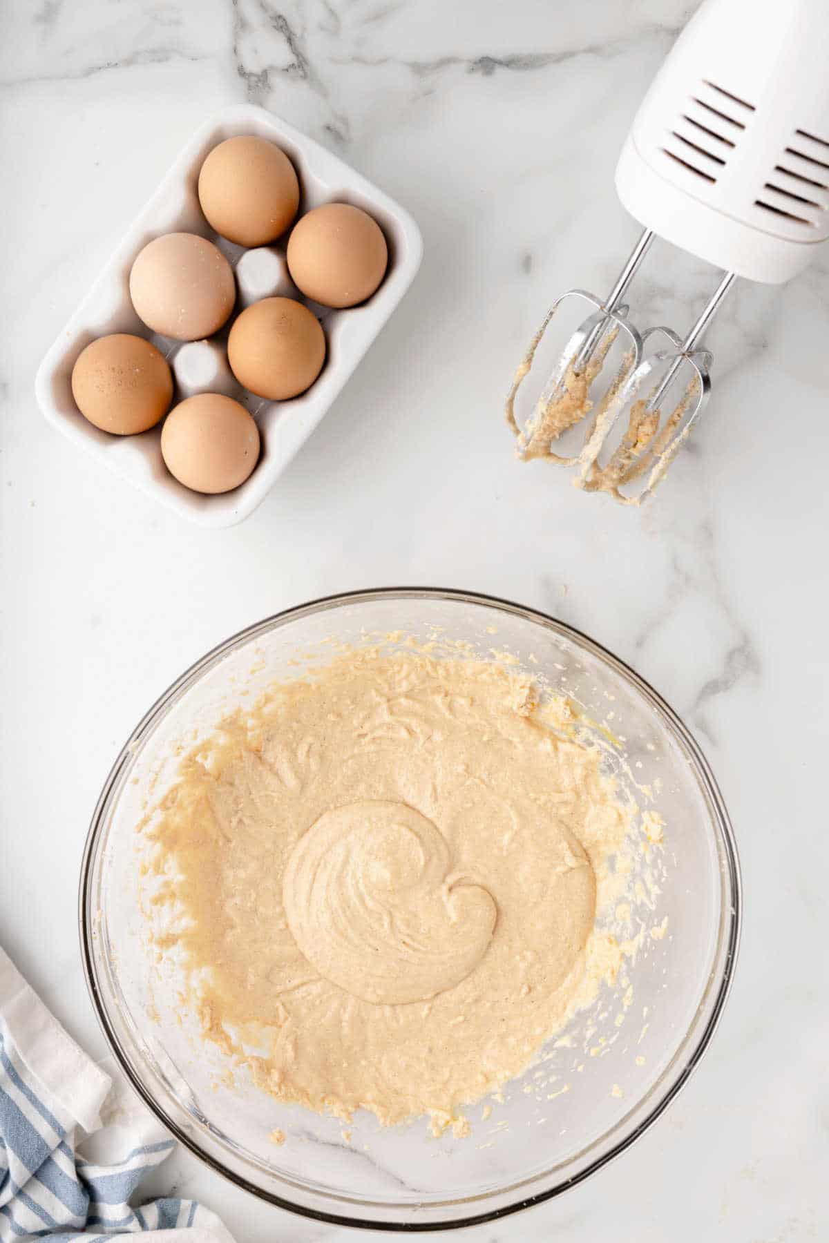 Eggs mixed into creamed butter mixture.
