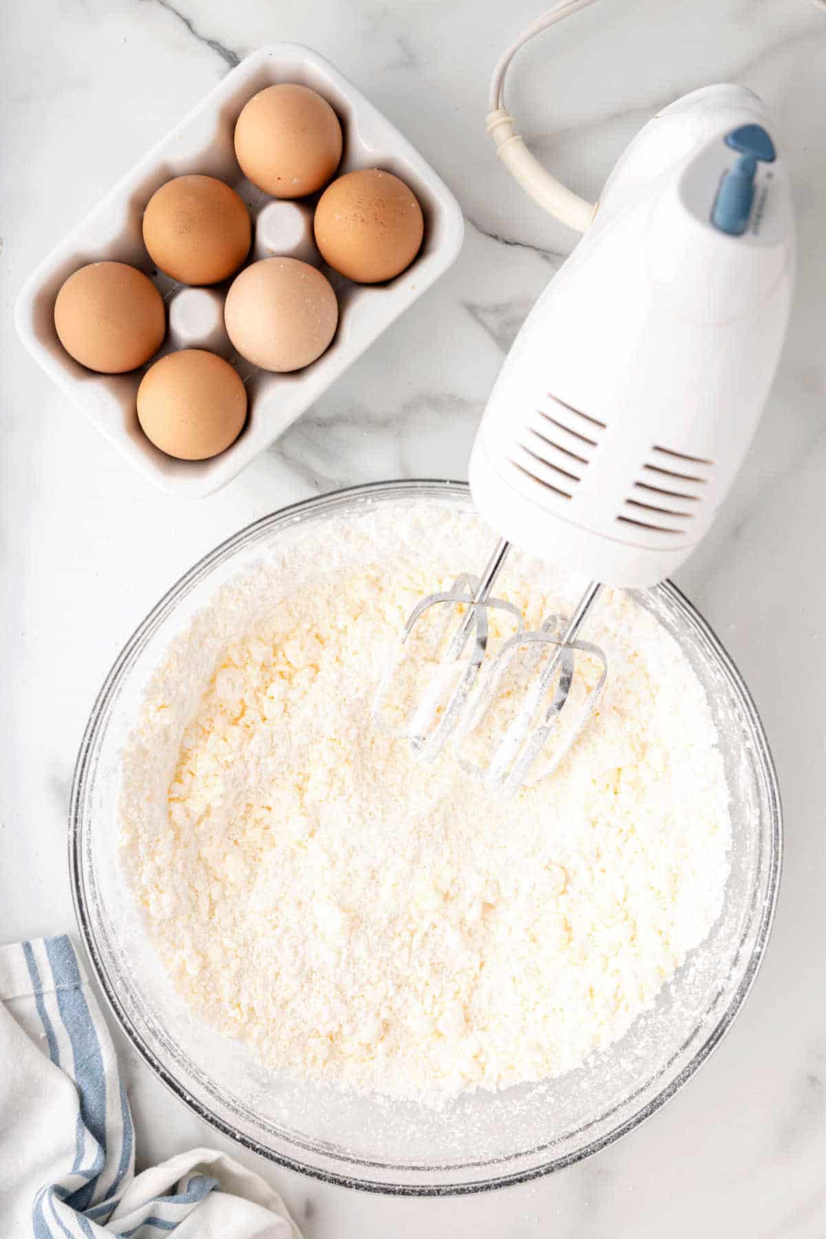 Buttercream frosting in a glass mixing bowl. 