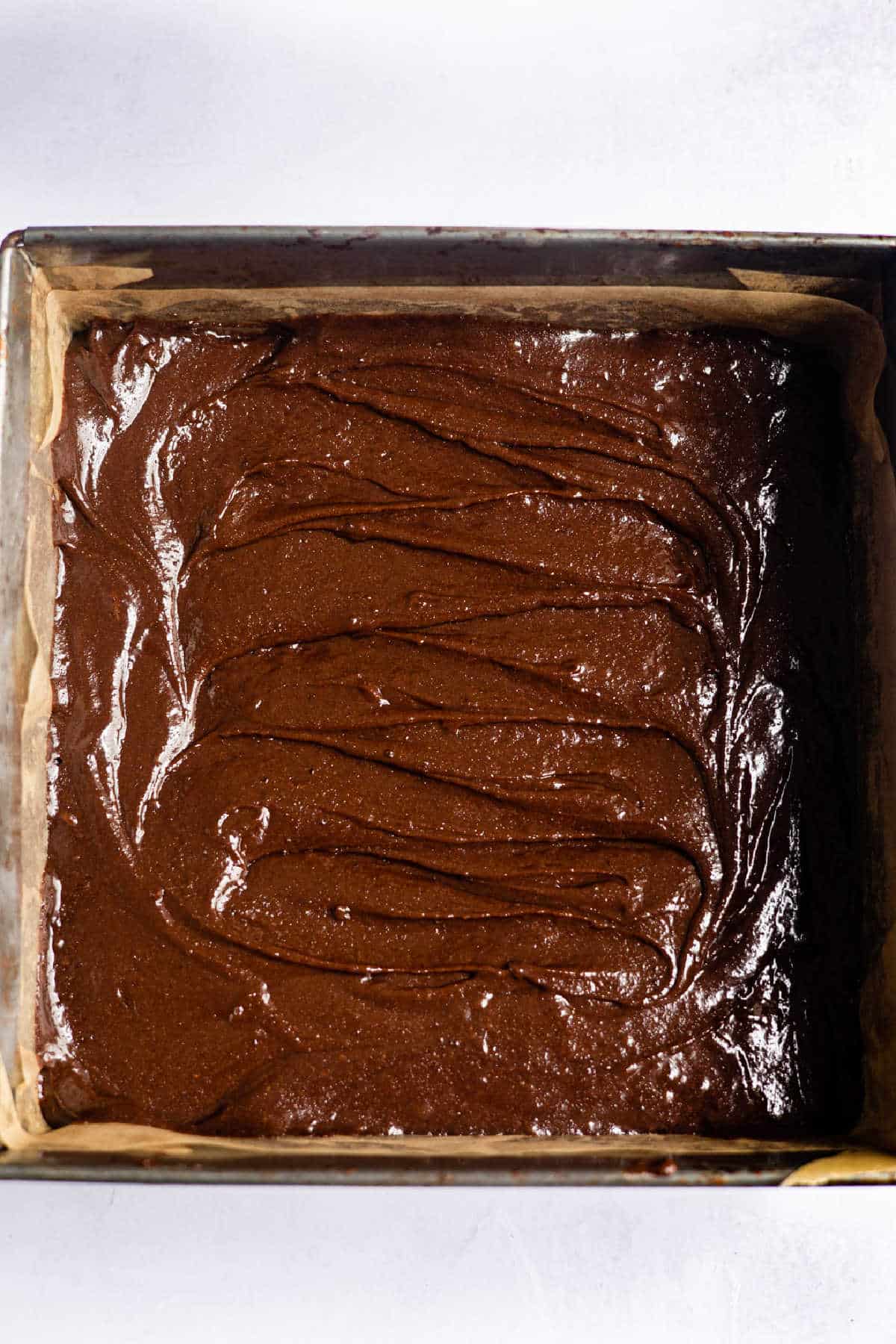 Brownie batter in a 9 by 9 pan.