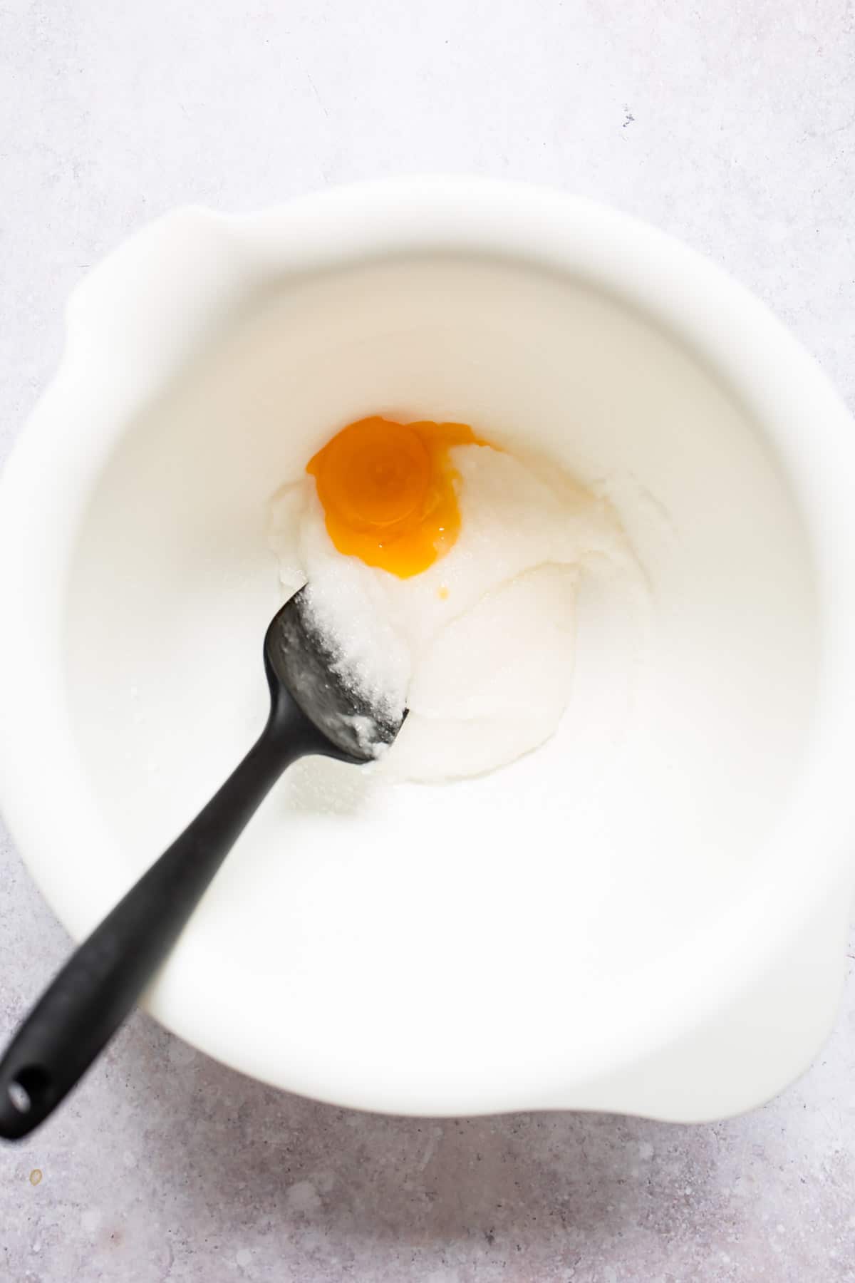 Egg yolk in sugar and oil mixture.