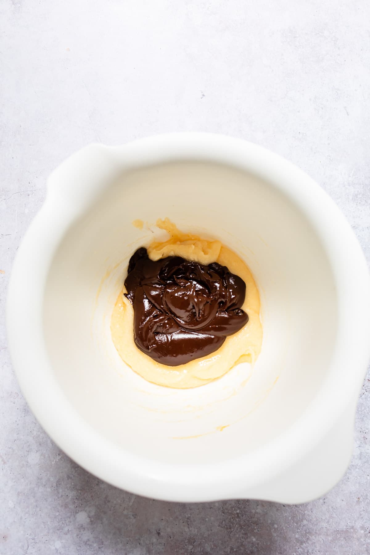 Melted chocolate mixture with egg yolk mixture.