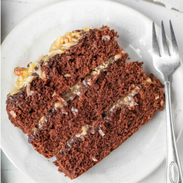 A slice of german chocolate cake on a white plate.