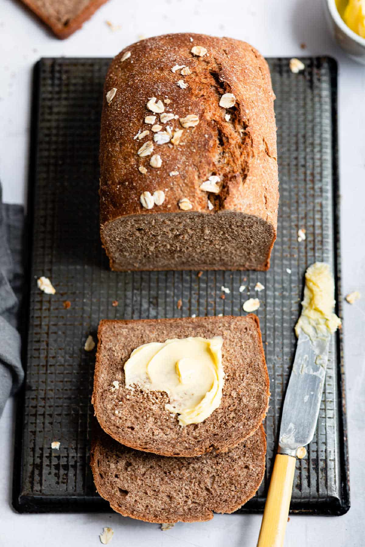 Loaf of outback bread with two slices buttered and cut.