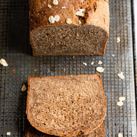 A loaf of outback bread with two slices cut.
