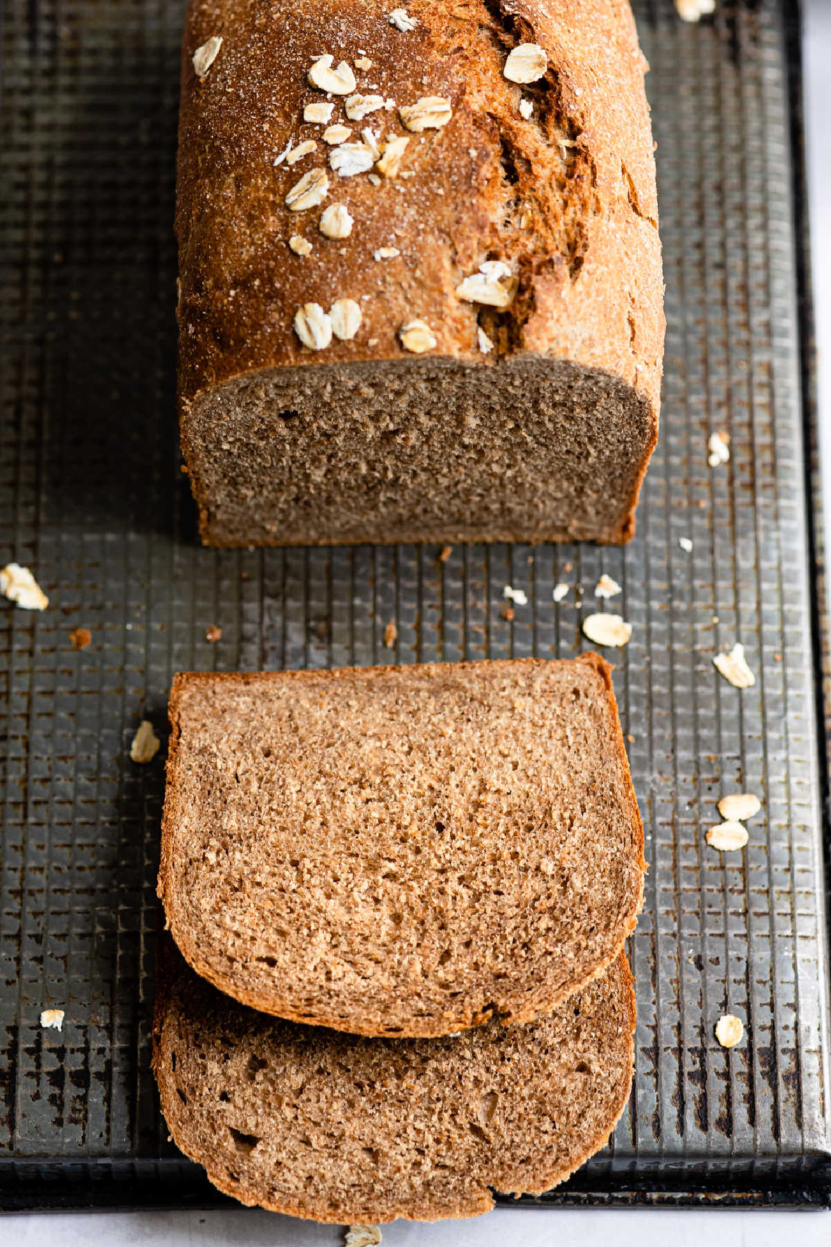 A loaf of outback bread with two slices cut. 