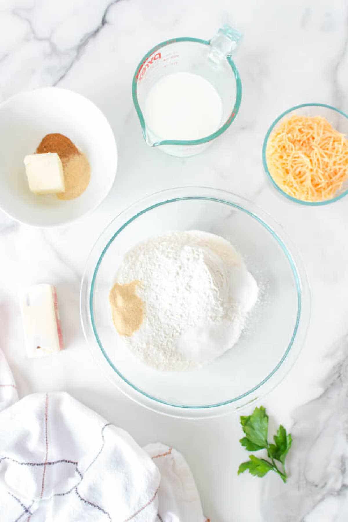 Ingredients for cheddar bay biscuits in dishes. 