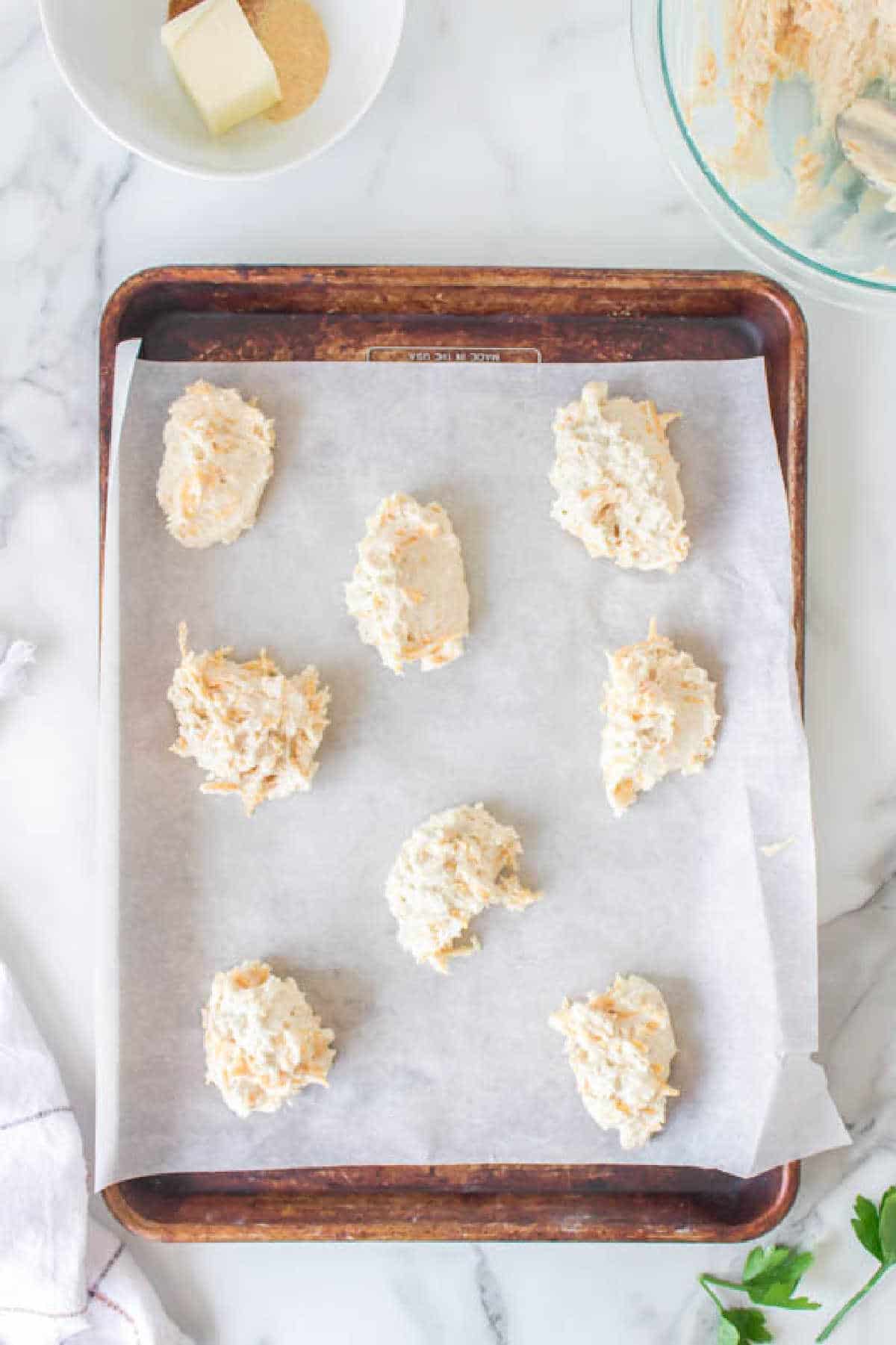 Cheddar bay biscuit dough on a baking sheet. 