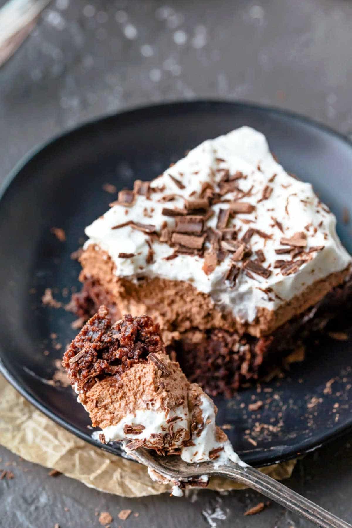 A fork taking a bite of French silk brownies. 