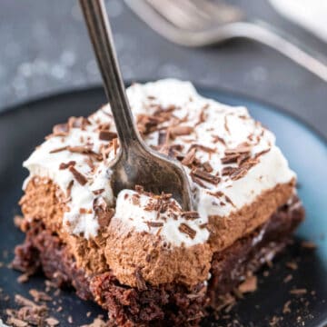 Silver fork taking a bite of a French silk brownie.