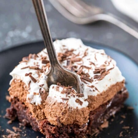 Silver fork taking a bite of a French silk brownie.