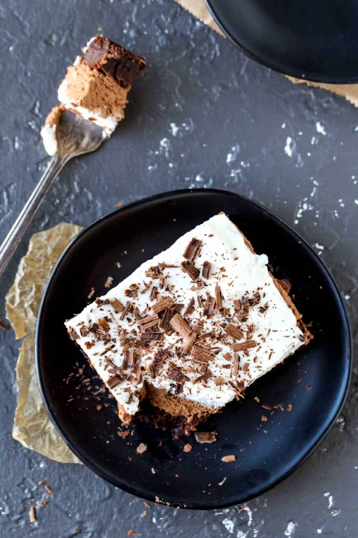 Overhead picture of French silk brownies with bite on fork next to the plate.