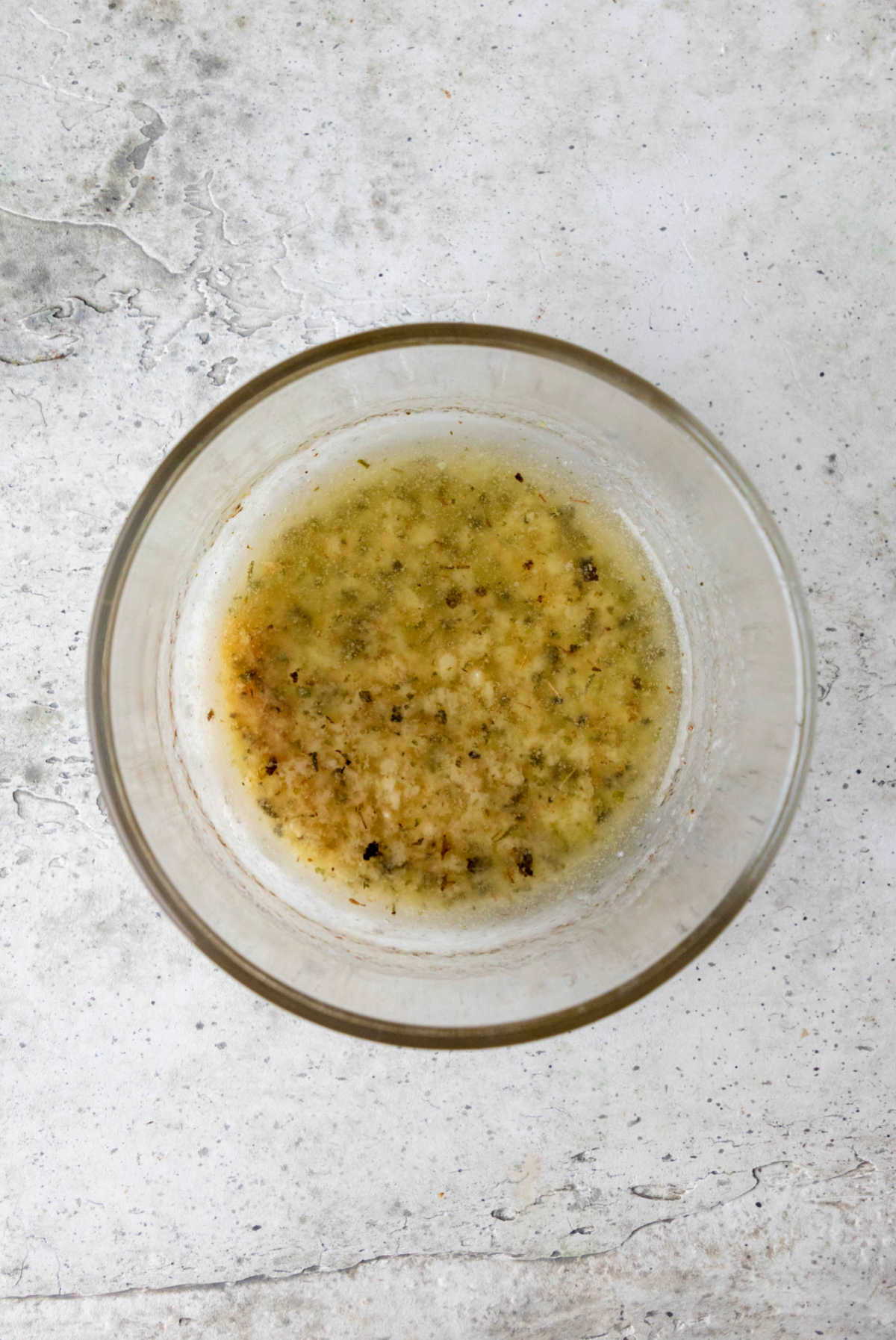 Garlic butter in a glass mixing bowl. 