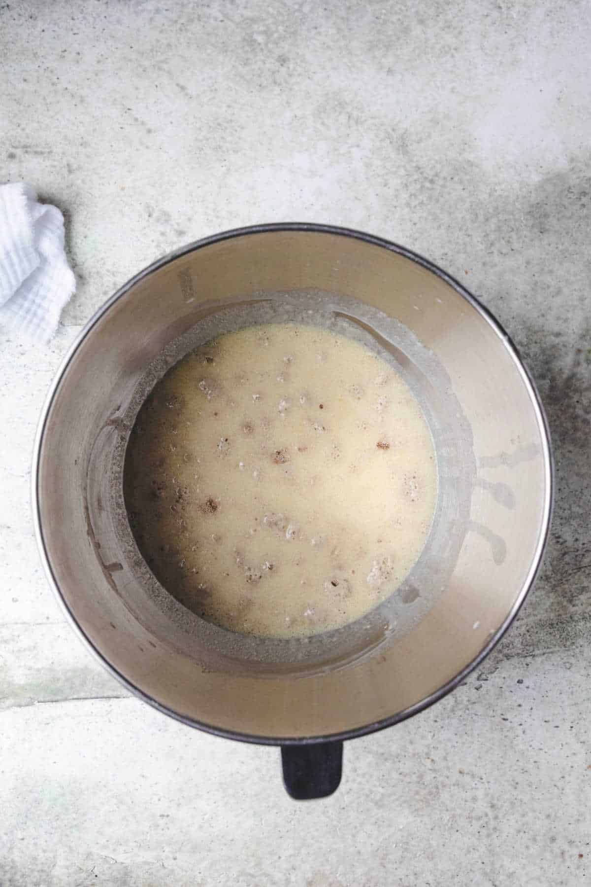 Wet ingredients in a silver mixing bowl. 