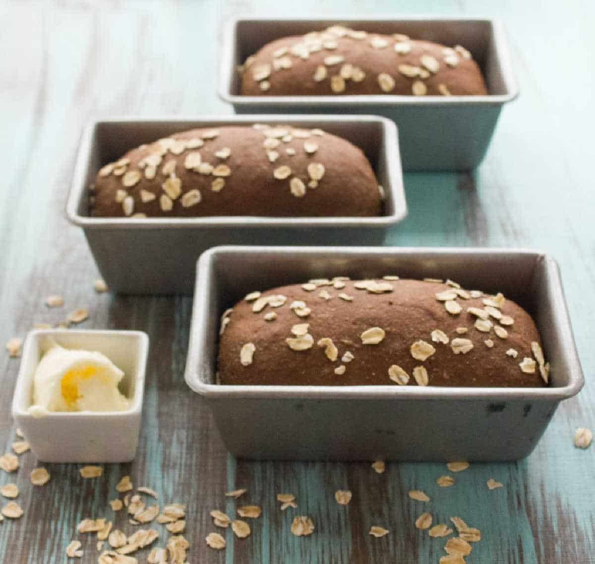 Outback Steakhouse Copycat Honey Wheat Bread in a pan next to butter.