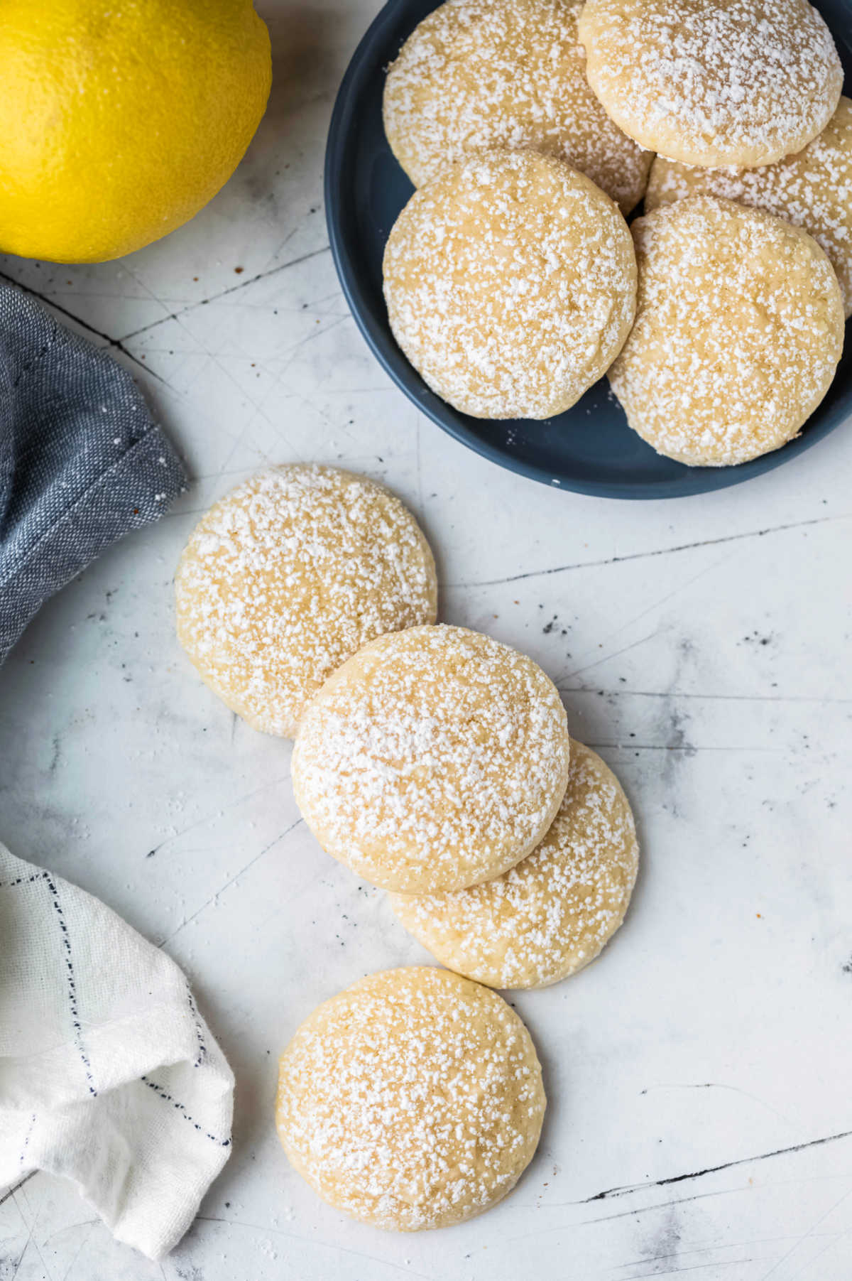 Four lemon cookies slightly overlapping each other on a white background. 