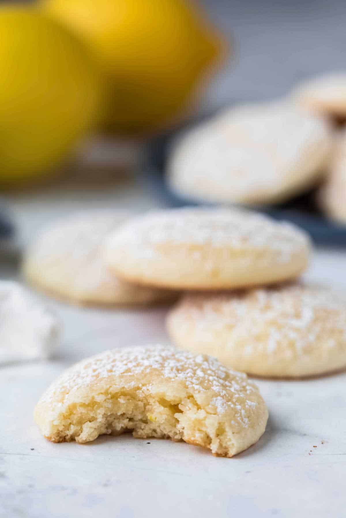 A lemon cookie with a bite missing. 