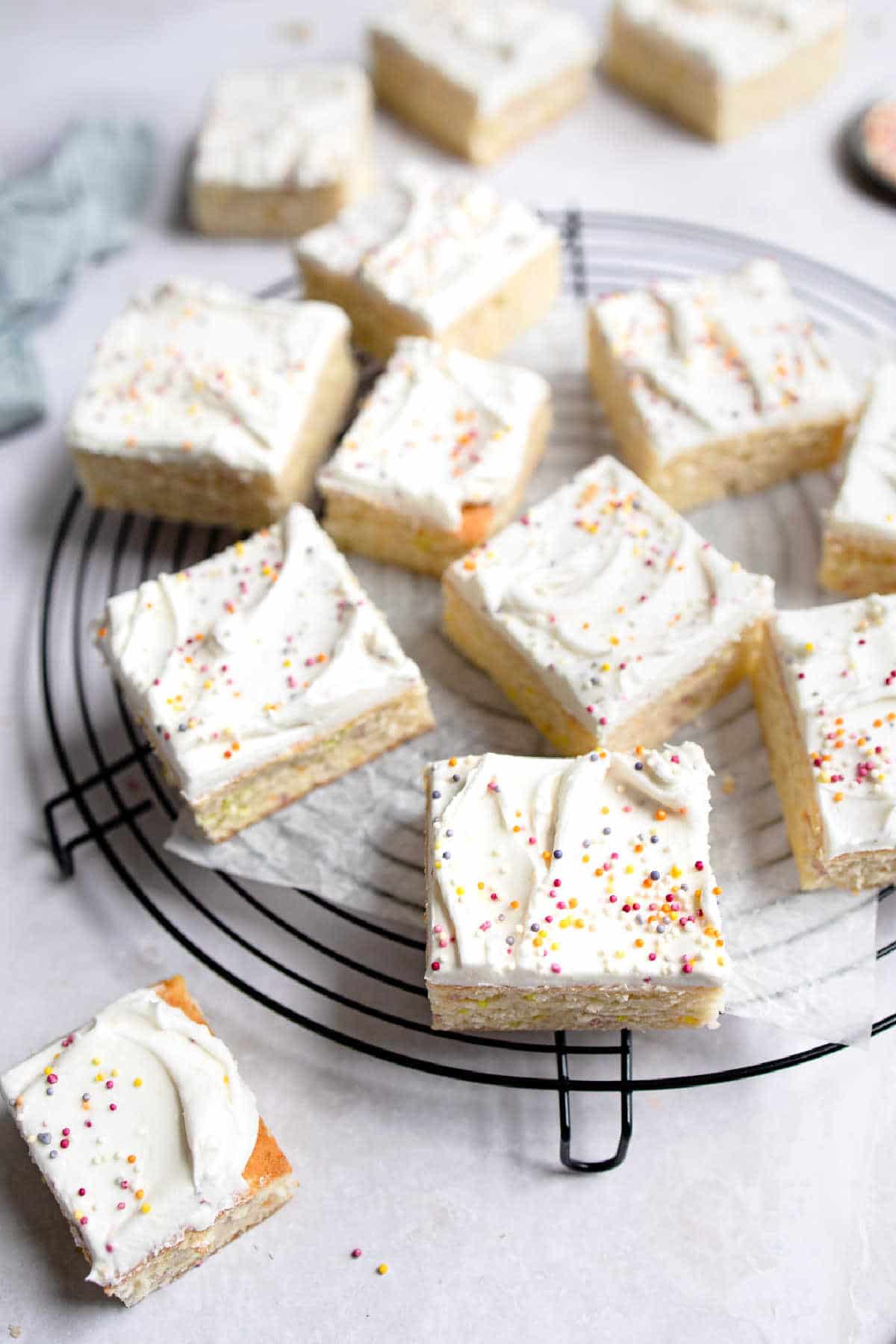 Slices of funfetti cake on a round cooling rack.