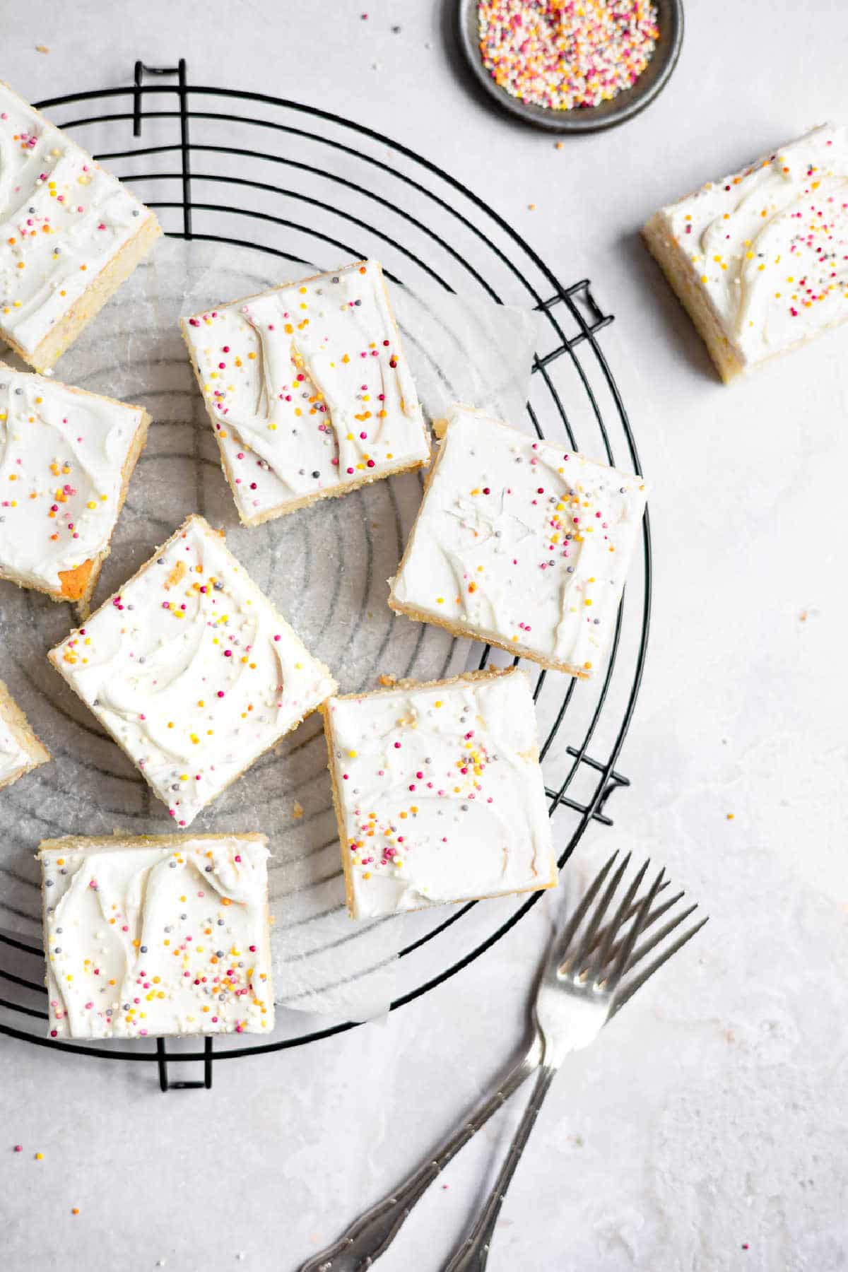 Slices of homemade funfetti cake on a wire cooling rack.
