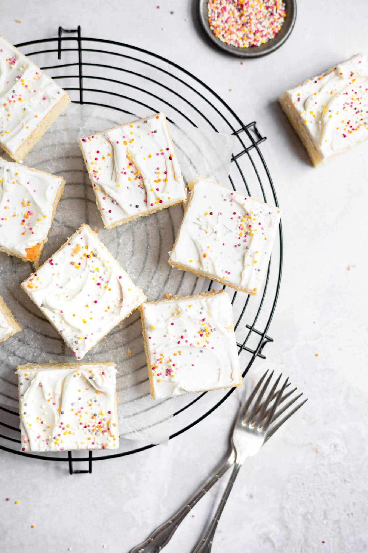 Slices of homemade funfetti cake on a wire cooling rack. 