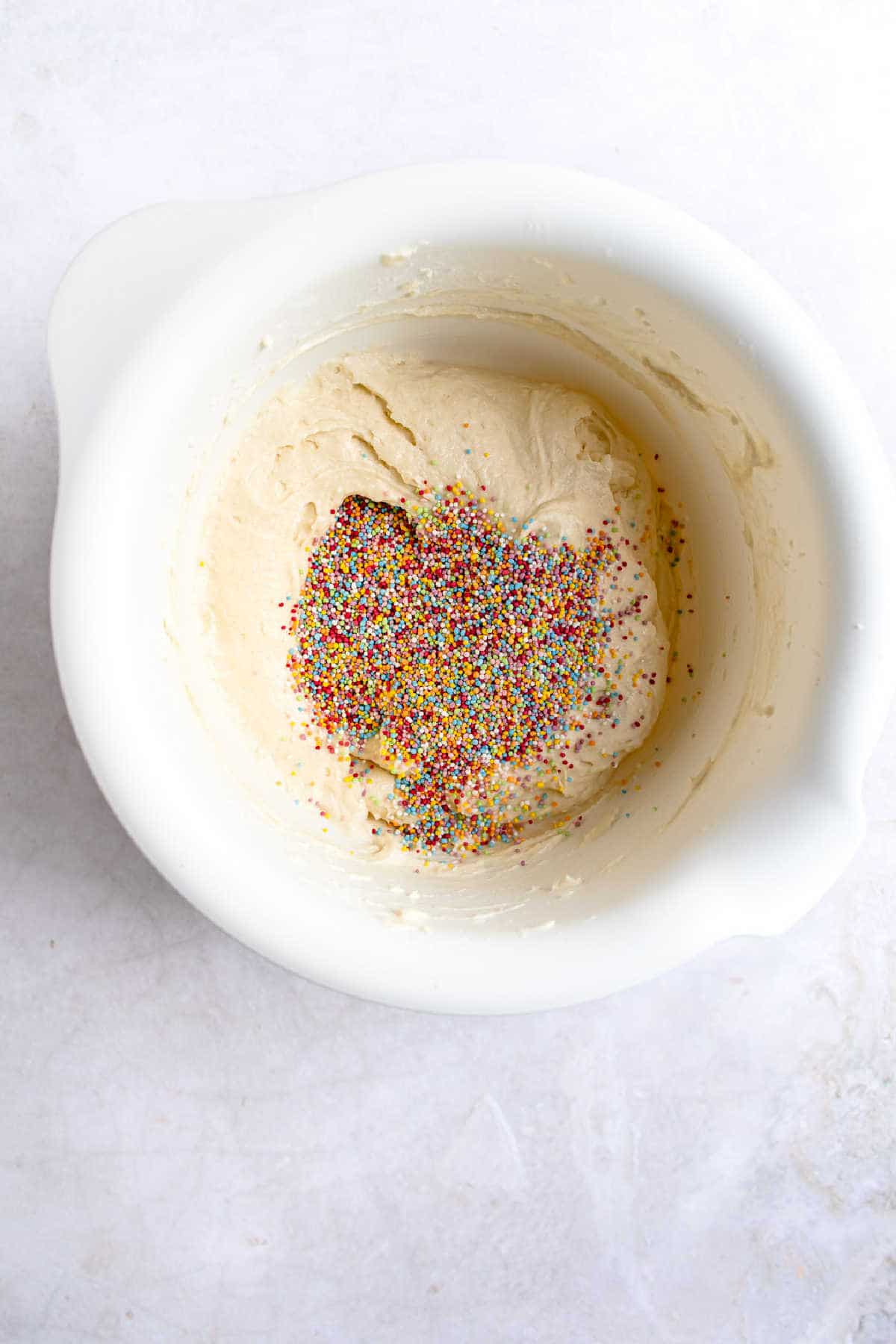 Sprinkles on top of cake batter. 