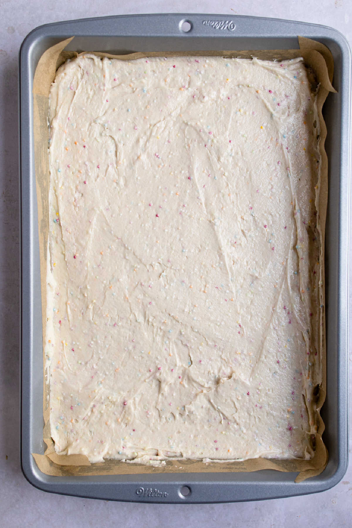 Cake batter in a cake pan.